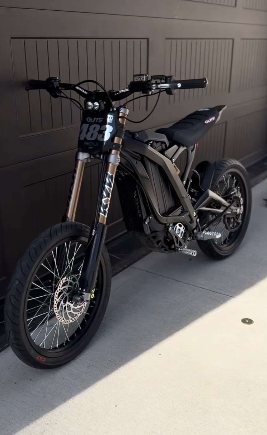 A real rider's blacked-out electric moto — the photo that gets admin-approved before they can rank